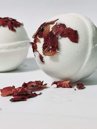 Herbaria Petal Pop Bath Bomb in white background with floral creative background – vegan French rose